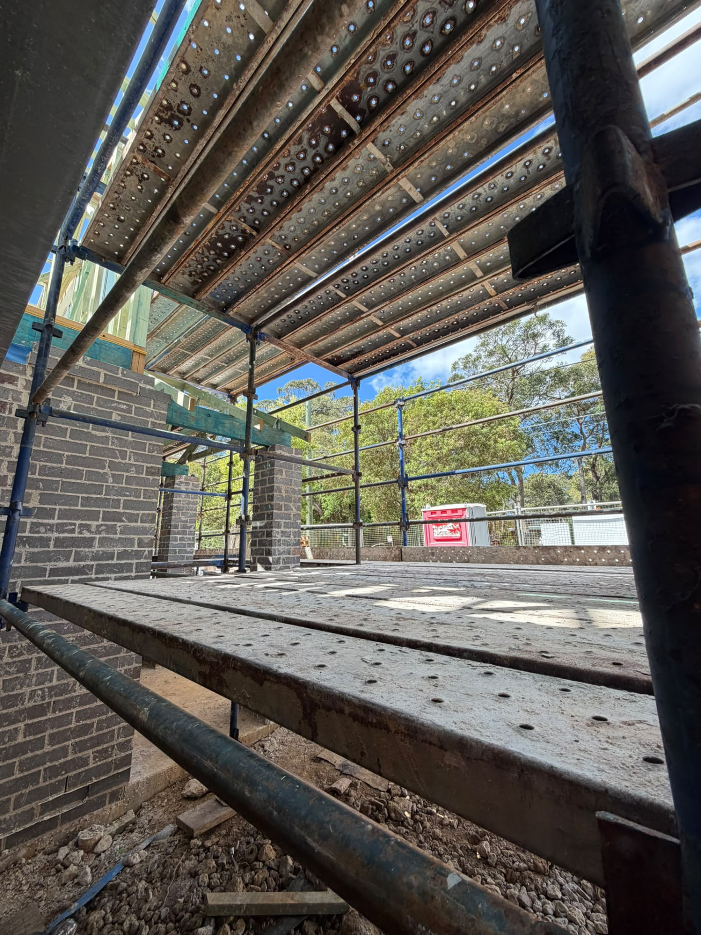 Perimeter scaffold with stair access around a new timber-frame home, view 2